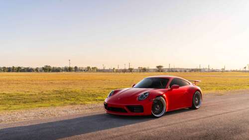 A sleek Porsche 992 GTS sports car featuring a polished exterior and iconic design. 8K desktop wallpaper