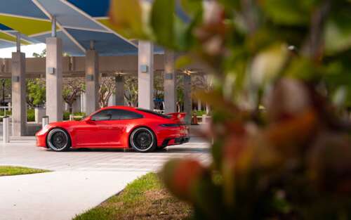 A sleek and modern Porsche 992 GTS sports car featuring aerodynamic design and aggressive... 7680x4800 free wallpaper