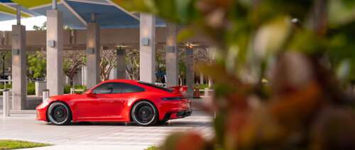 A sleek and modern Porsche 992 GTS sports car featuring aerodynamic design and aggressive... UWUHD desktop wallpaper