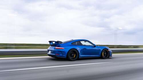 A high-performance Porsche GT3 RS sports car featuring aerodynamic racing elements. 8K ps4 wallpaper