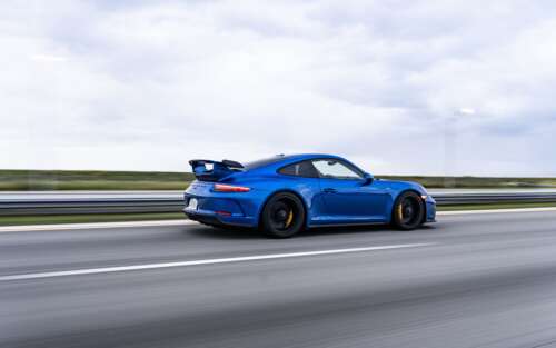 A high-performance Porsche GT3 RS sports car featuring aerodynamic racing elements. 7680x4800 hd background