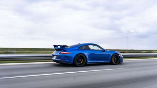 A high-performance Porsche GT3 RS sports car featuring aerodynamic racing elements. 4K (Ultra HD) free desktop wallpaper