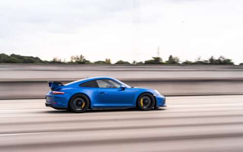 A high-performance Porsche GT3 RS sports car featuring aggressive aerodynamic styling. 7680x4800 free background