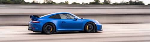 A high-performance Porsche GT3 RS sports car featuring aggressive aerodynamic styling. Dual UHD hd background