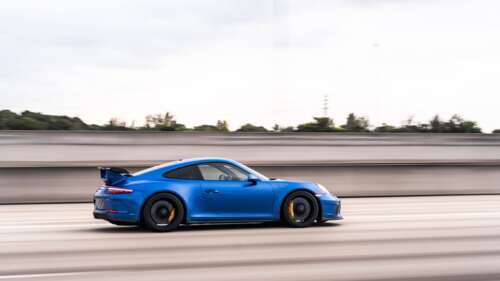 A high-performance Porsche GT3 RS sports car featuring aggressive aerodynamic styling. 4K (Ultra HD) free background images