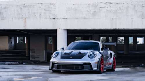 A sleek and powerful Porsche GT3 RS showcasing its aerodynamic contours and iconic... 4K (Ultra HD) free background