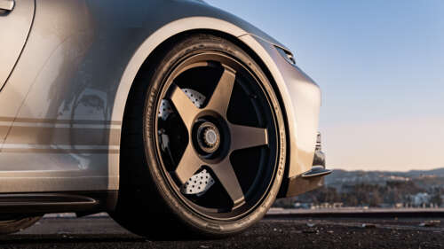 A high-performance Porsche GT3 RS sports car featuring aggressive aerodynamic styling. 8K free background