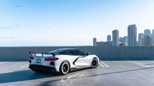 A detailed view of a Chevrolet Corvette C8 sports car, showcasing its aerodynamic... 8K free desktop wallpaper