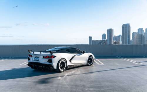 A detailed view of a Chevrolet Corvette C8 sports car, showcasing its aerodynamic... 7680x4800 wallpaper photo gallery download