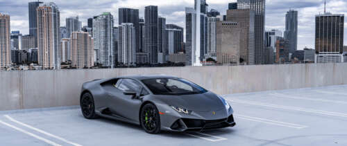 A close-up shot of a modern Lamborghini Huracán supercar in a dramatic setting. UWUHD free background