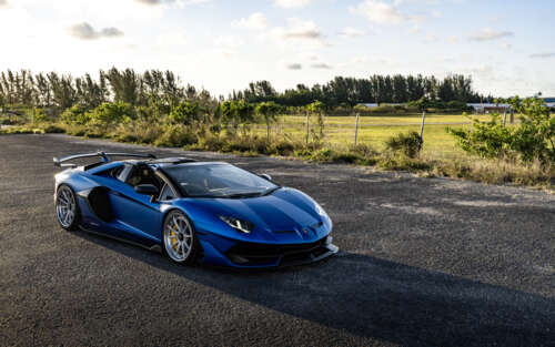 A high-performance Lamborghini supercar featuring iconic aerodynamic curves and a... 7680x4800 wallpaper