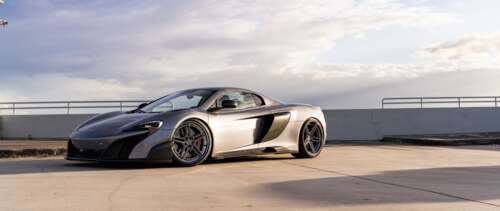 A high-performance McLaren supercar featuring sleek aerodynamic lines and a polished... UWUHD wallpaper photo gallery download