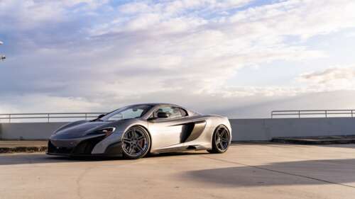 A high-performance McLaren supercar featuring sleek aerodynamic lines and a polished... 8K free background