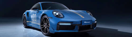 A detailed view of a sleek, high-performance Porsche 911 Turbo sports car featuring... Dual UHD hd background