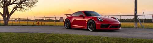 Close-up shot of a Porsche 992 GTS sports car featuring its iconic silhouette and... Dual UHD free desktop wallpaper