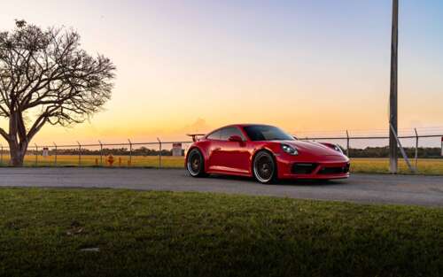 Close-up shot of a Porsche 992 GTS sports car featuring its iconic silhouette and... 7680x4800 free background images
