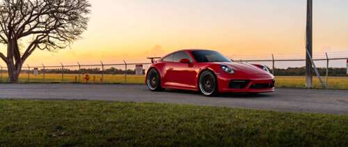 Close-up shot of a Porsche 992 GTS sports car featuring its iconic silhouette and... UWUHD wallpaper download