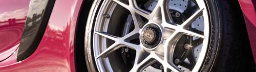 A sleek, high-performance Porsche sports car captured in a stunning light. Dual UHD wallpaper photo gallery download