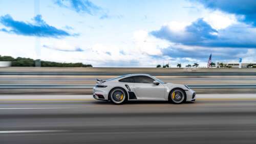 A close-up view of a luxury Porsche sports car featuring a sleek design and metallic... 4K (Ultra HD) ps4 wallpaper