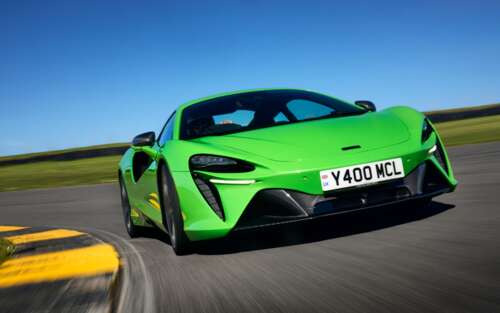 A bright green McLaren Artura luxury supercar featuring aerodynamic curves and a... 7680x4800 free hd wallpapers