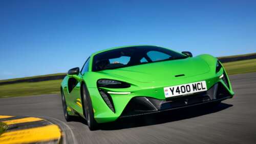 A bright green McLaren Artura luxury supercar featuring aerodynamic curves and a... 4K (Ultra HD) hd background