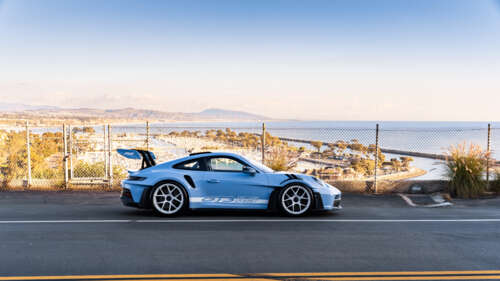 A sleek and polished Porsche sports car featuring modern aerodynamic design. 8K wallpaper for pc download
