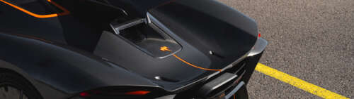 A sleek and aerodynamic Koenigsegg Jesko Absolut hypercar in a high-performance setting. Dual UHD hd background