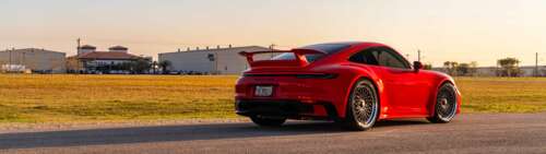 A high-resolution, close-up shot of a sleek Porsche 992 GTS sports car featuring... Dual UHD wallpaper photo gallery download