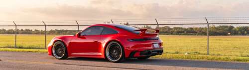 A professional photograph of a Porsche 992 GTS sports car. Dual UHD wallpaper
