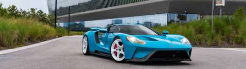 A high-performance Ford GT supercar featuring its signature aerodynamic body and... Dual UHD wallpaper photo gallery download