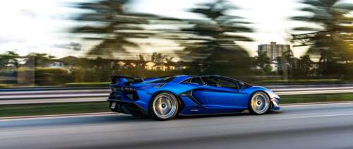 A close-up view of a Lamborghini Aventador SVJ showcasing its aggressive aerodynamic... UWUHD background images hd