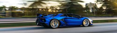 A close-up view of a Lamborghini Aventador SVJ showcasing its aggressive aerodynamic... Dual UHD free wallpaper