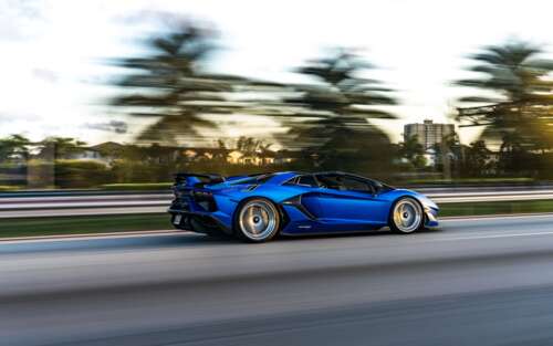 A close-up view of a Lamborghini Aventador SVJ showcasing its aggressive aerodynamic... 7680x4800 wallpaper for laptop download