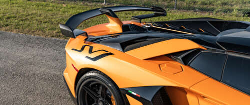 A high-performance Lamborghini Aventador SVJ supercar displaying aggressive aerodynamic... UWUHD wallpaper for pc download