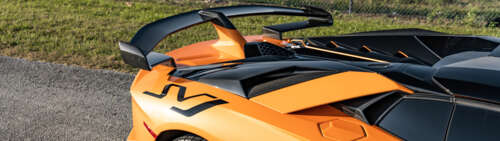 A high-performance Lamborghini Aventador SVJ supercar displaying aggressive aerodynamic... Dual UHD wallpaper images