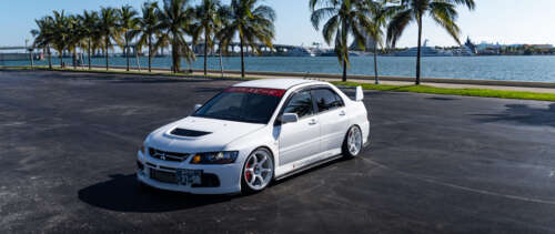 High-performance Mitsubishi Lancer Evolution IX sports sedan in a striking pose UWUHD wallpaper download