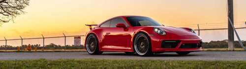 A sleek and powerful Porsche 992 GTS sports car showcasing its modern aerodynamic... Dual UHD background images hd