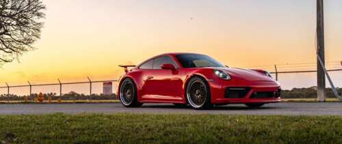 A sleek and powerful Porsche 992 GTS sports car showcasing its modern aerodynamic... UWUHD free background images