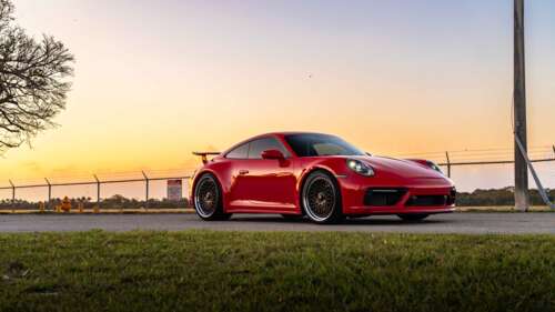 A sleek and powerful Porsche 992 GTS sports car showcasing its modern aerodynamic... 4K (Ultra HD) high definition wallpaper