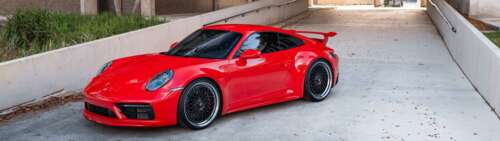 A detailed view of a Porsche 992 GTS sports car highlighting its aerodynamic body... Dual UHD desktop wallpaper