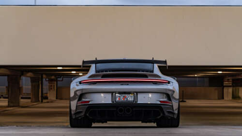 A detailed close-up of a high-performance Porsche 911 GT3 RS sports car. 8K desktop wallpaper