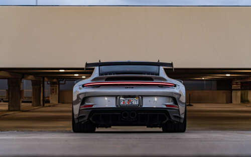 A detailed close-up of a high-performance Porsche 911 GT3 RS sports car. 7680x4800 high definition wallpaper