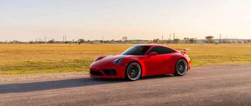 A sleek and powerful Porsche 992 GTS sports car featuring modern aerodynamic design... UWUHD hd background