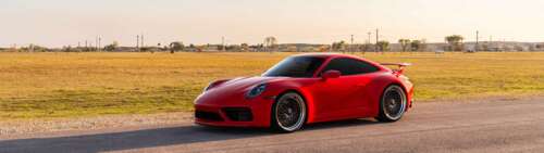 A sleek and powerful Porsche 992 GTS sports car featuring modern aerodynamic design... Dual UHD high definition wallpaper
