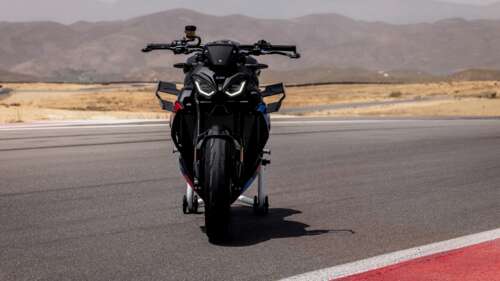 A close-up view of the futuristic 2026 BMW M 1000 R motorcycle on an asphalt road. free wallpaper