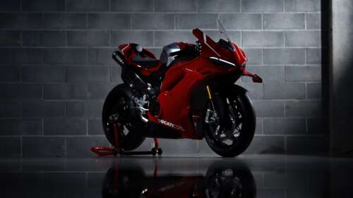 A high-resolution, detailed shot of a sleek red Ducati Panigale V4 R performance... wallpaper for laptop download