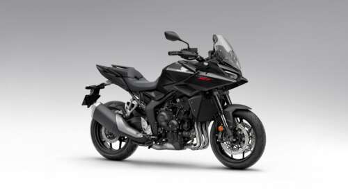 A sleek black 2026 Honda CB1000GT touring motorcycle with aerodynamic fairings and... free wallpaper