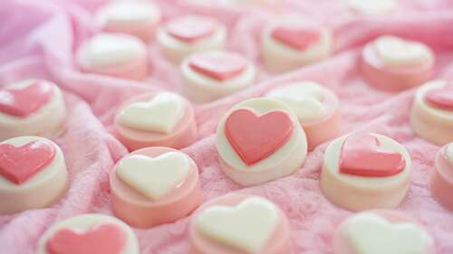 A collection of pastel pink heart-shaped candies and Valentine's Day sweets in an... background images hd