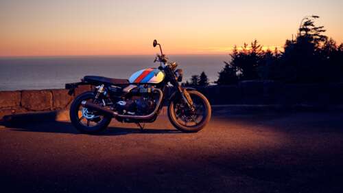 A sleek motorcycle silhouetted against a vibrant orange and gold sunset sky during... 4K (Ultra HD) desktop wallpaper
