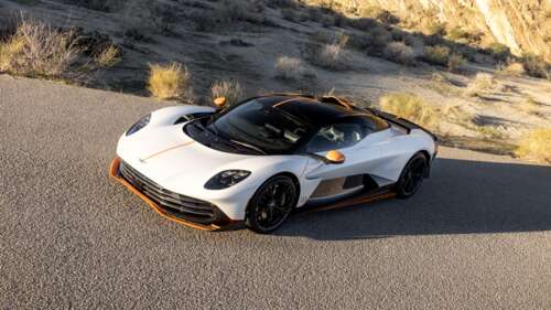 A sleek and aerodynamic white 2025 Aston Martin Valhalla plug-in hybrid supercar. high definition wallpaper